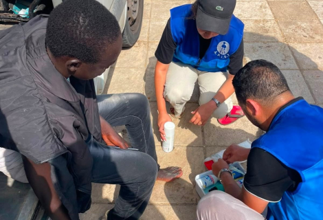 Aid workers assists an injured migrants on the Spain–Morocco border in Ceuta
